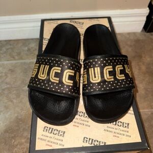 Gucci Black Slides with Gold Lettering